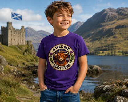 Young boy wearing the A Wee Bit Scottish youth t-shirt outdoors in the Scottish countryside.
