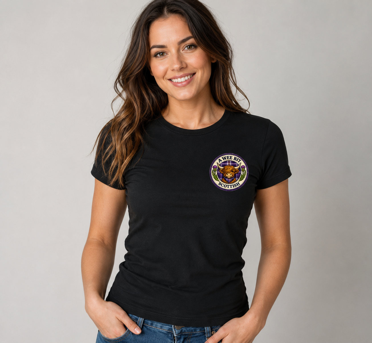 Ladies fitted black t-shirt featuring the A Wee Bit Scottish Highland cow badge design on the left chest.