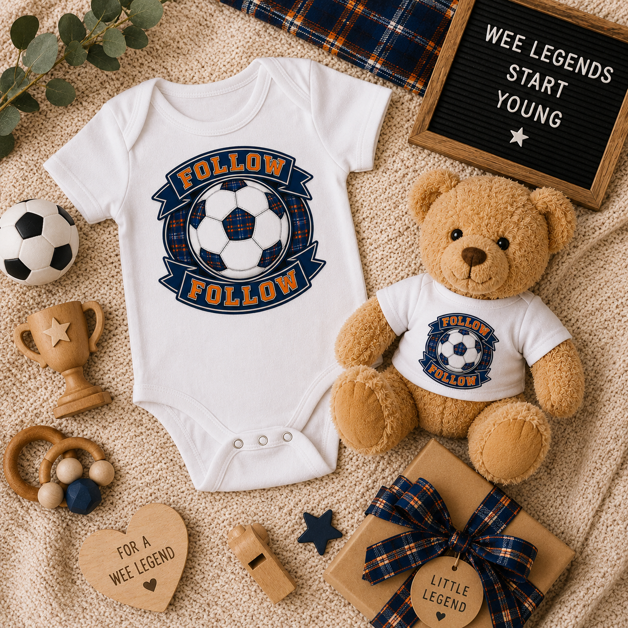FOLLOW FOLLOW baby gift set displayed on a cosy knitted blanket with matching bodysuit, teddy bear and football-inspired accessories.