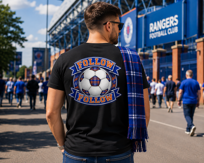 Man wearing a black FOLLOW FOLLOW men's t-shirt with a large football-inspired back print while walking toward a stadium on match day.