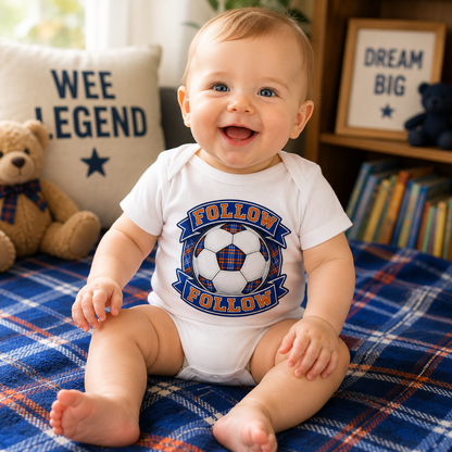 Baby wearing FOLLOW FOLLOW Scottish football bodysuit sitting and smiling