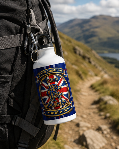 If You Cannae Dae The Bouncy aluminium sports water bottle clipped to a hiking backpack on a mountain trail with the tartan design clearly visible.