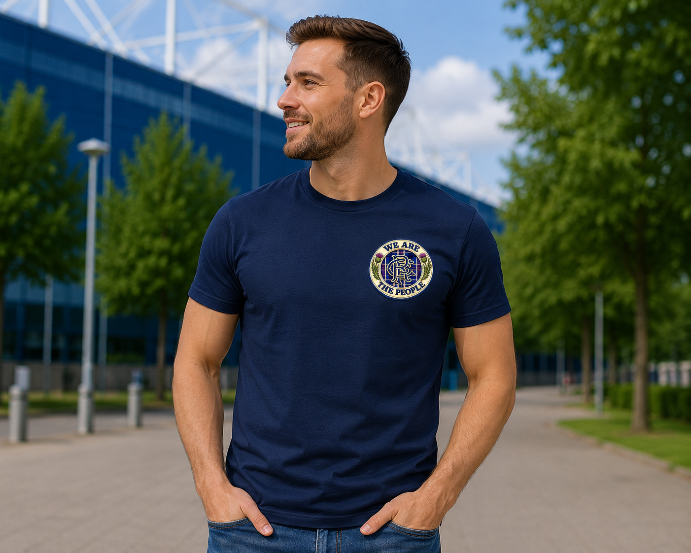 Football supporter wearing a navy We Are The People Crest men's t-shirt at a stadium featuring a small left chest badge design.