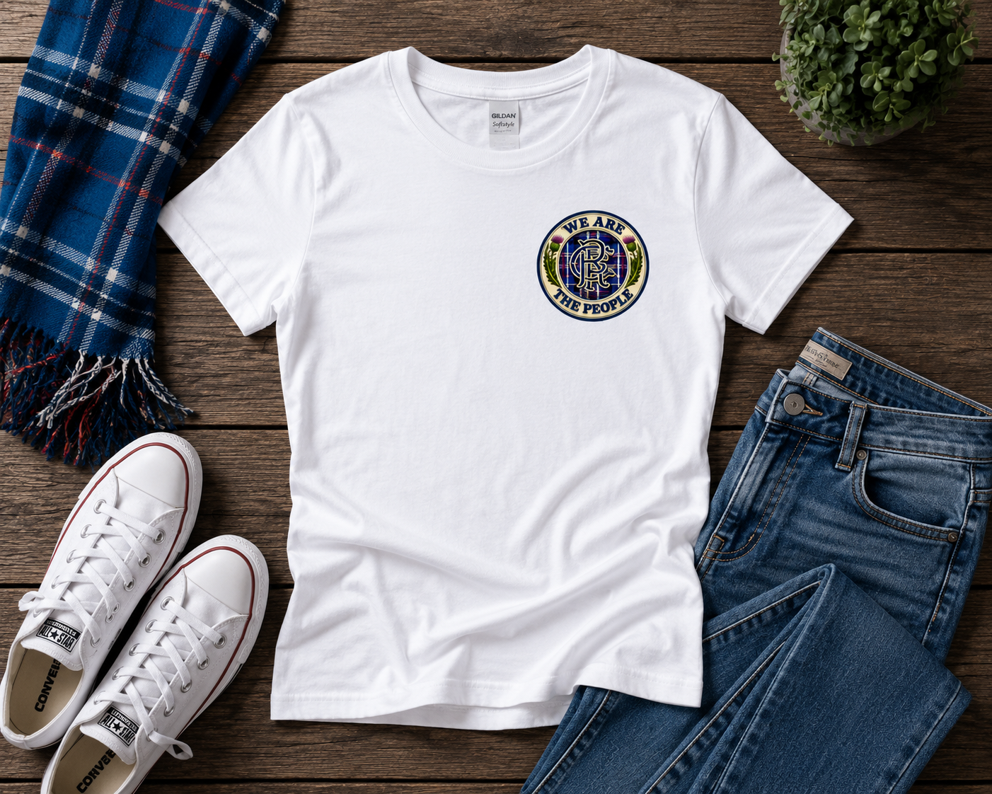 We Are The People Crest ladies fitted t-shirt displayed in a flat lay arrangement with jeans, white trainers and a blue tartan scarf.