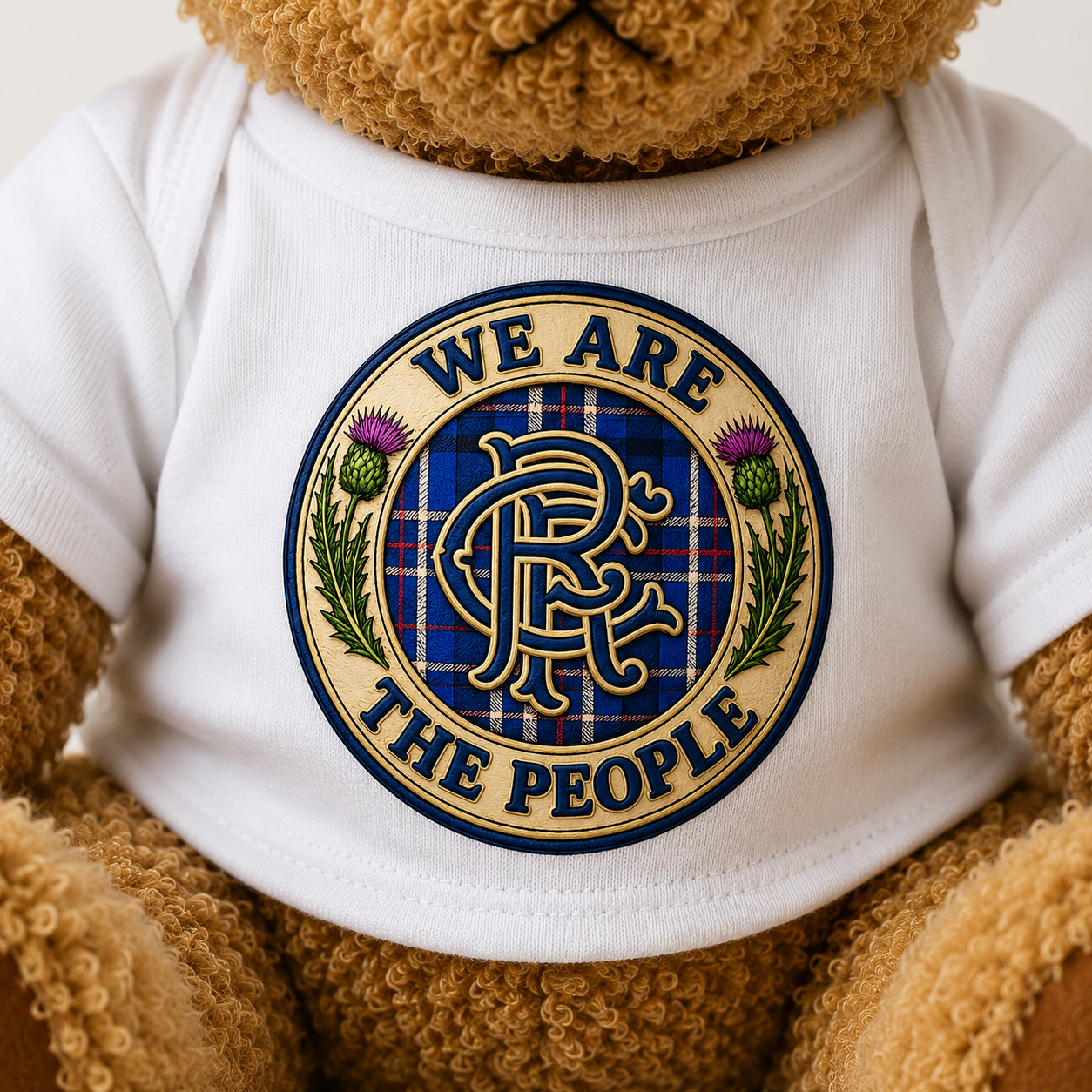 Close-up of the We Are The People Crest design printed on the teddy bear's white t-shirt.