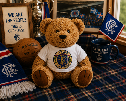 We Are The People Crest teddy bear displayed among Scottish football and tartan themed memorabilia.