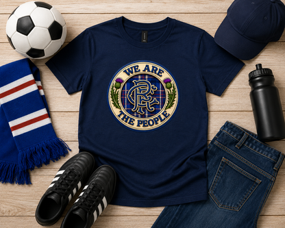 Navy We Are The People crest youth t-shirt displayed in a football-themed flat lay with scarf, football, trainers, cap, water bottle and jeans.