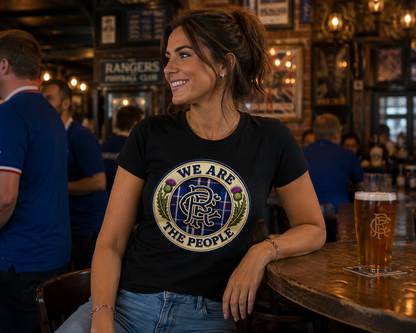 Women's fitted We Are The People t-shirt styled with everyday casual wear, showcasing the detailed Scottish crest and tartan artwork.
