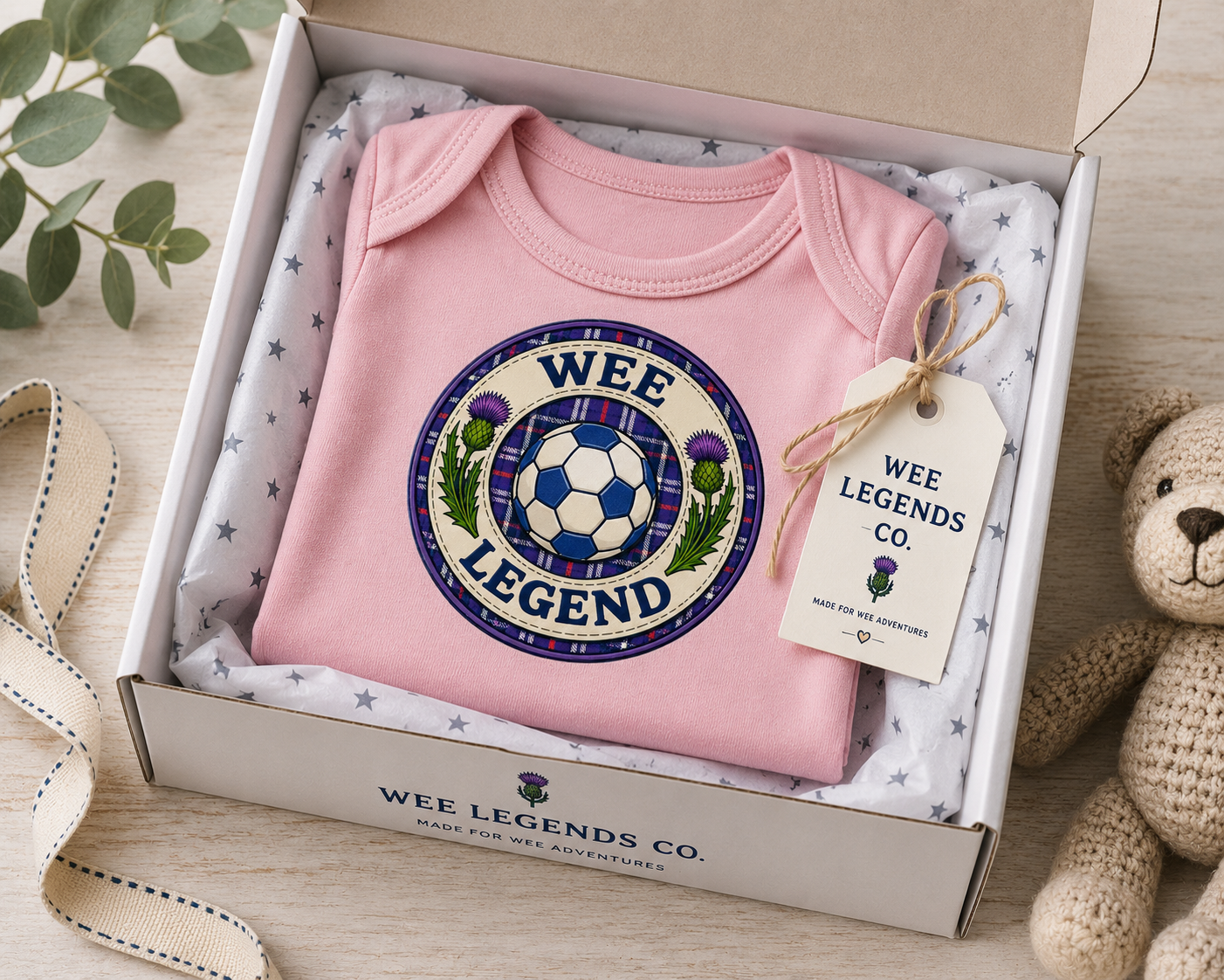 Wee Legend baby bodysuit presented in a gift box with tissue paper and Wee Legends Co gift tag.