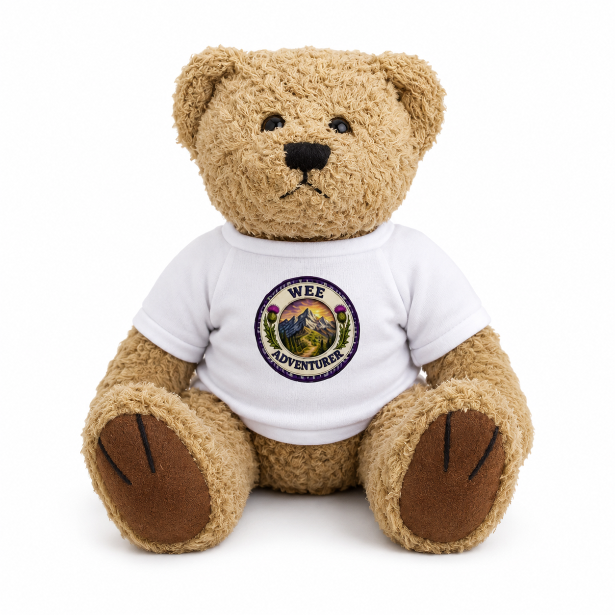 Wee Adventurer Teddy Bear wearing a white t-shirt with mountain adventure badge design on a white background