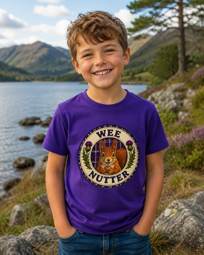 Young child wearing the Wee Nutter youth t-shirt featuring a cheerful squirrel crest with tartan background and Scottish thistles.