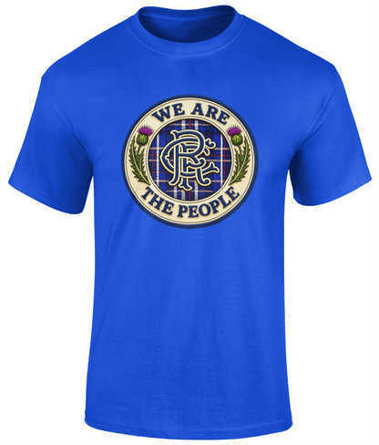 We Are The People Crest youth t-shirt in royal blue featuring a navy tartan crest with Scottish thistles and heritage-inspired lettering.
