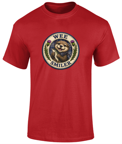 Wee Smiler youth t-shirt in red featuring a smiling otter crest holding a fish with tartan and thistle details.