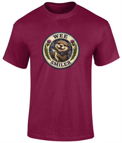 Wee Smiler youth t-shirt in cardinal red featuring a smiling otter crest holding a fish with tartan and thistle details.