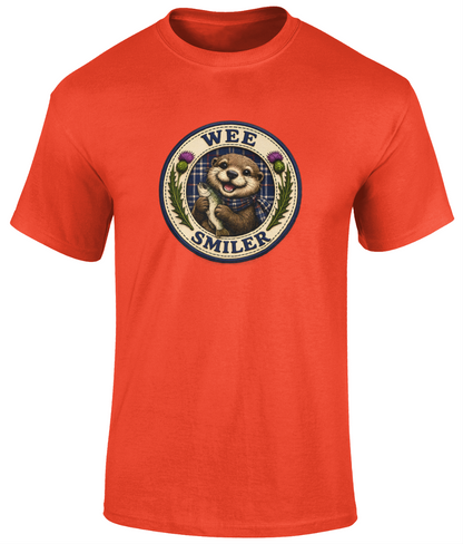 Wee Smiler youth t-shirt in orange featuring a smiling otter crest holding a fish with tartan and thistle details.