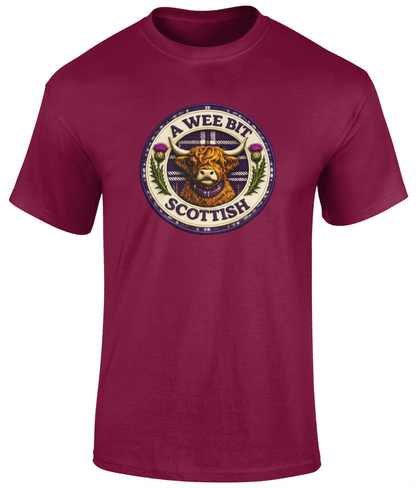 A Wee Bit Scottish youth t-shirt featuring a Highland cow badge design displayed on a cardinal red t-shirt.