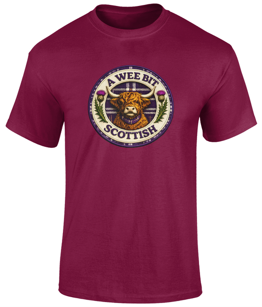 A Wee Bit Scottish youth t-shirt featuring a Highland cow badge design displayed on a cardinal red t-shirt.