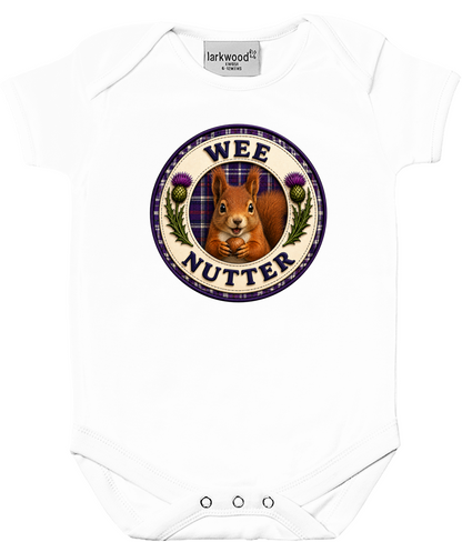 White baby bodysuit featuring the Wee Nutter squirrel badge design with Scottish tartan detailing and thistle artwork.