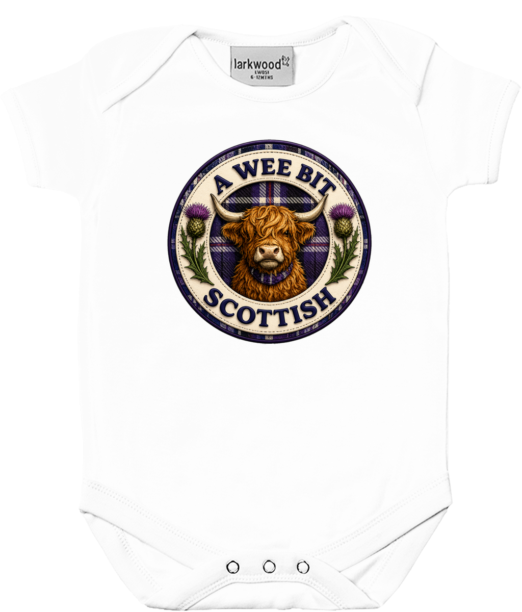 A Wee Bit Scottish baby bodysuit featuring a Highland Cow badge design inspired by Scotland, with tartan accents and thistle artwork on a white baby grow.