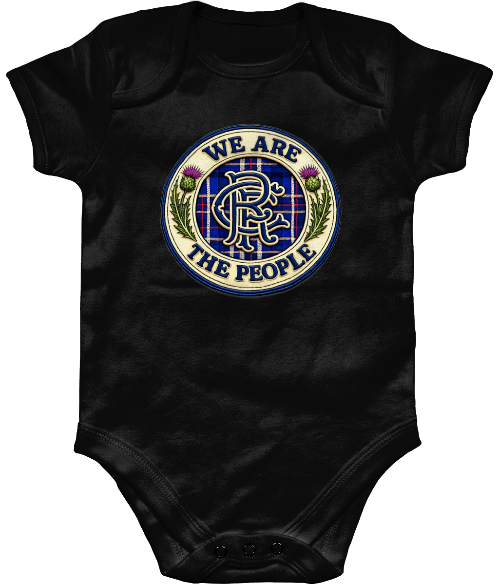 We Are The People badge baby bodysuit in black featuring tartan crest design with Scottish thistles and blue embroidered-style detailing.